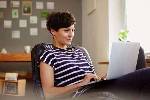 Woman smiling at laptop